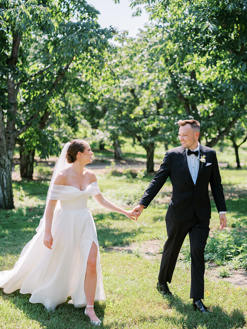 Abby & Jake holding hands a first look before their Bay View Wedding