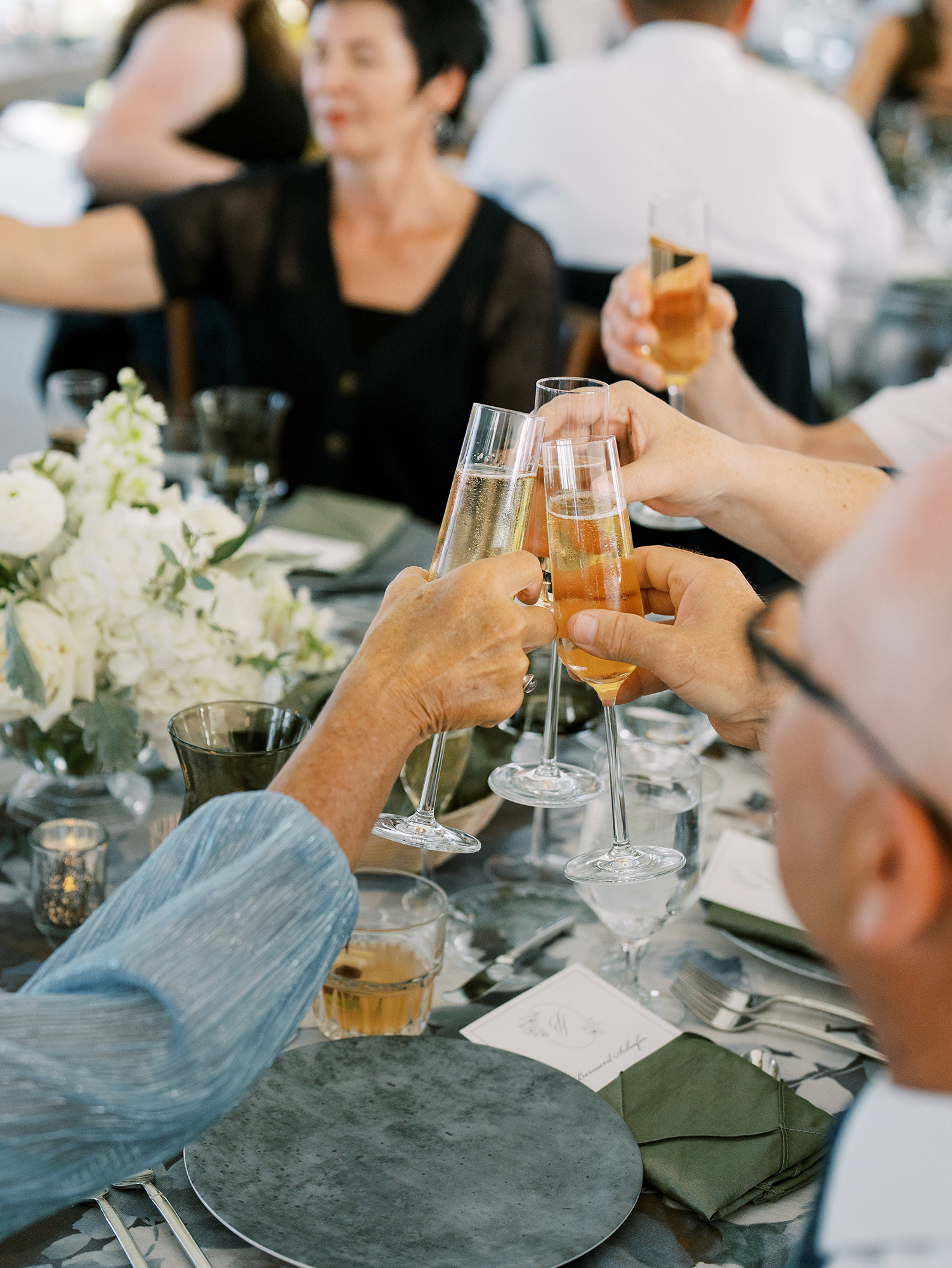 glasses clinking on jen and josh wedding day at bay view weddings